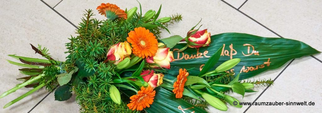 Trauerstrauß mit Rosen, Lilien, Gerbera und handbeschriebenen Blättern