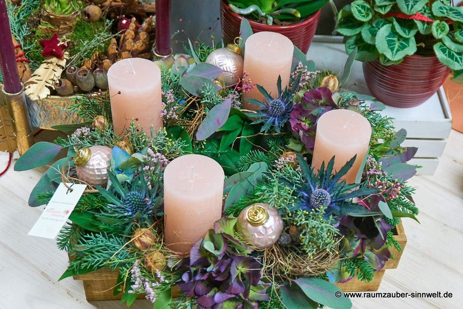 Handgefertigter klassischer Adventskranz aus Naturmaterialien und Kugeln mit vier Kerzen und Weihnachtsdekoration