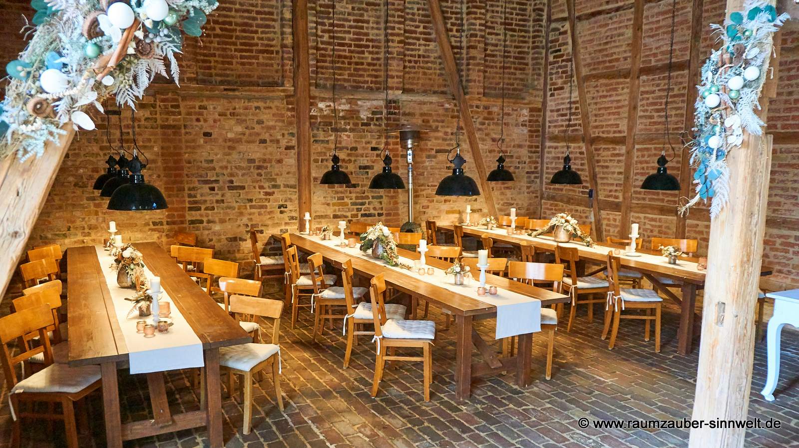 Winterliche Saaldekoration aus Naturmaterialien und Kugeln.