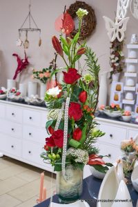 Frischblumengesteck aus roten Rosen, Lilien, Freesien und Trachelium